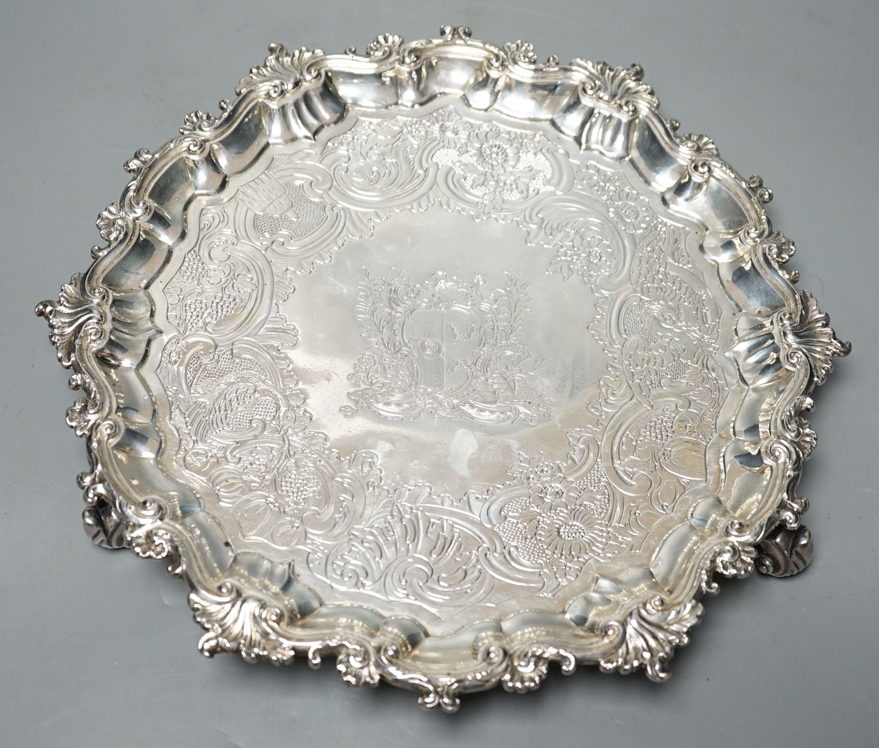 A George II silver salver, Hugh Mills, London, 1748, with later engraved decoration, 28.6cm, 25.5 oz (a.f.).